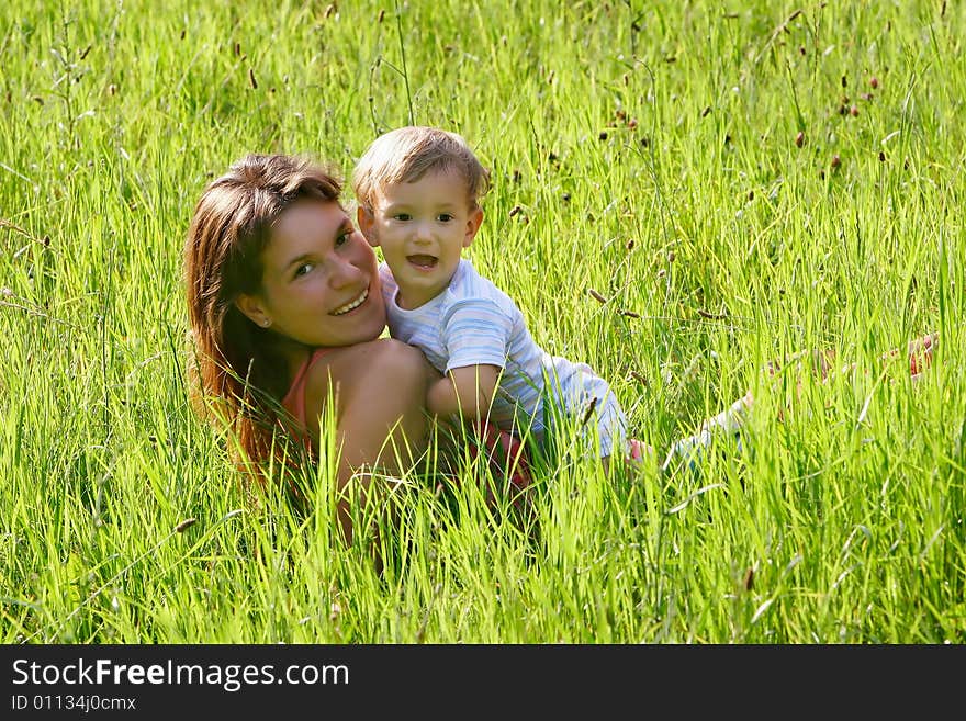 Happy mother and son playing in grass