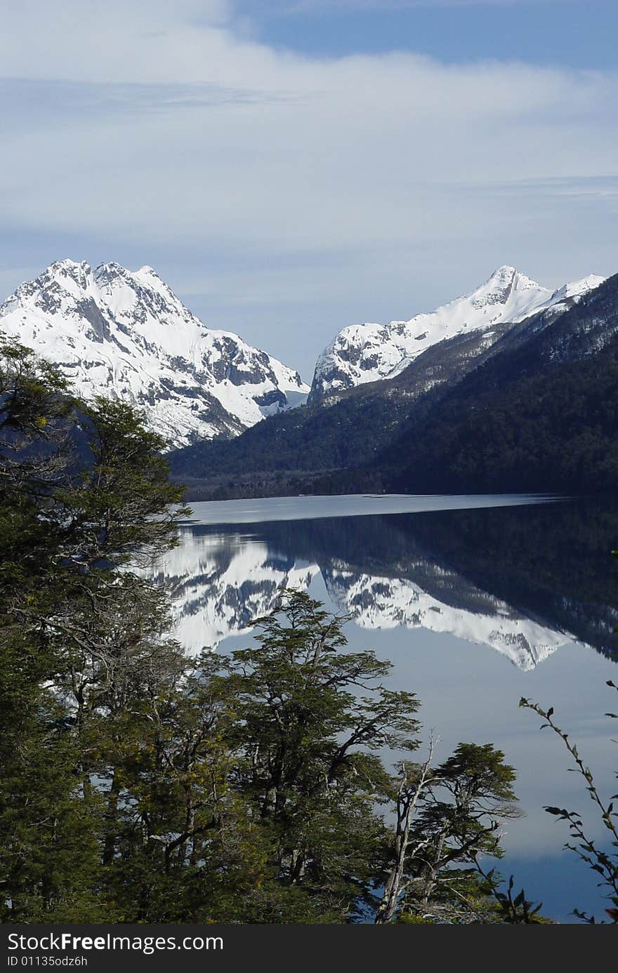 Snow-capped mountains are reflected on the lake. Snow-capped mountains are reflected on the lake