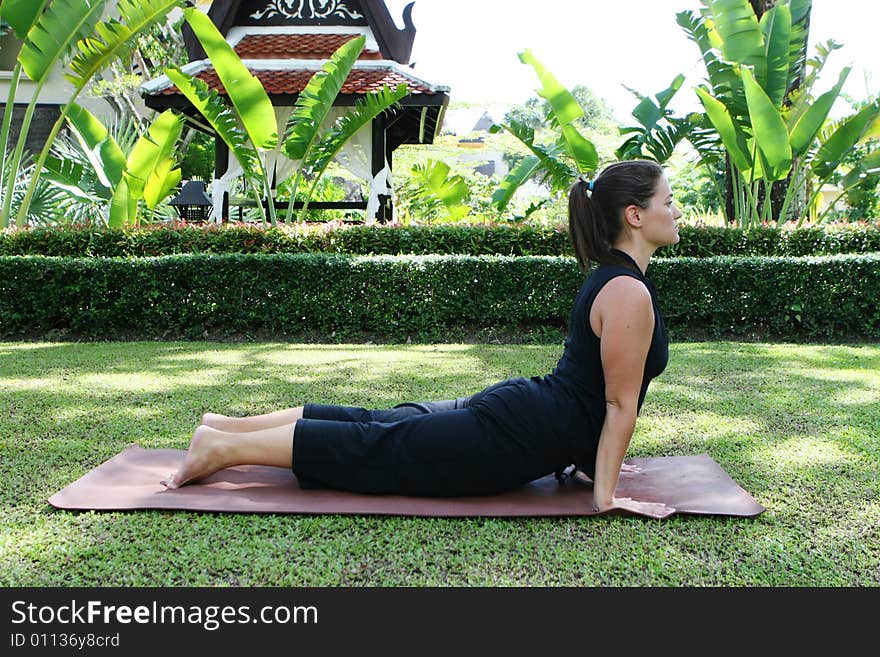 Young woman practicing yoga in the park.