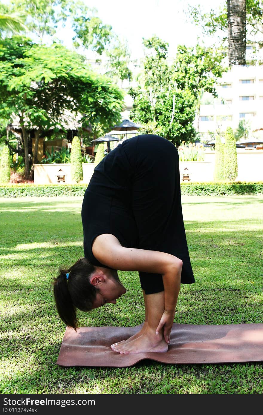 Young woman practicing yoga in the park.