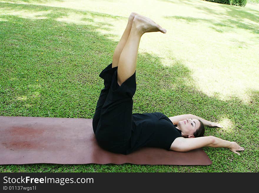 Young woman practicing yoga in the park.