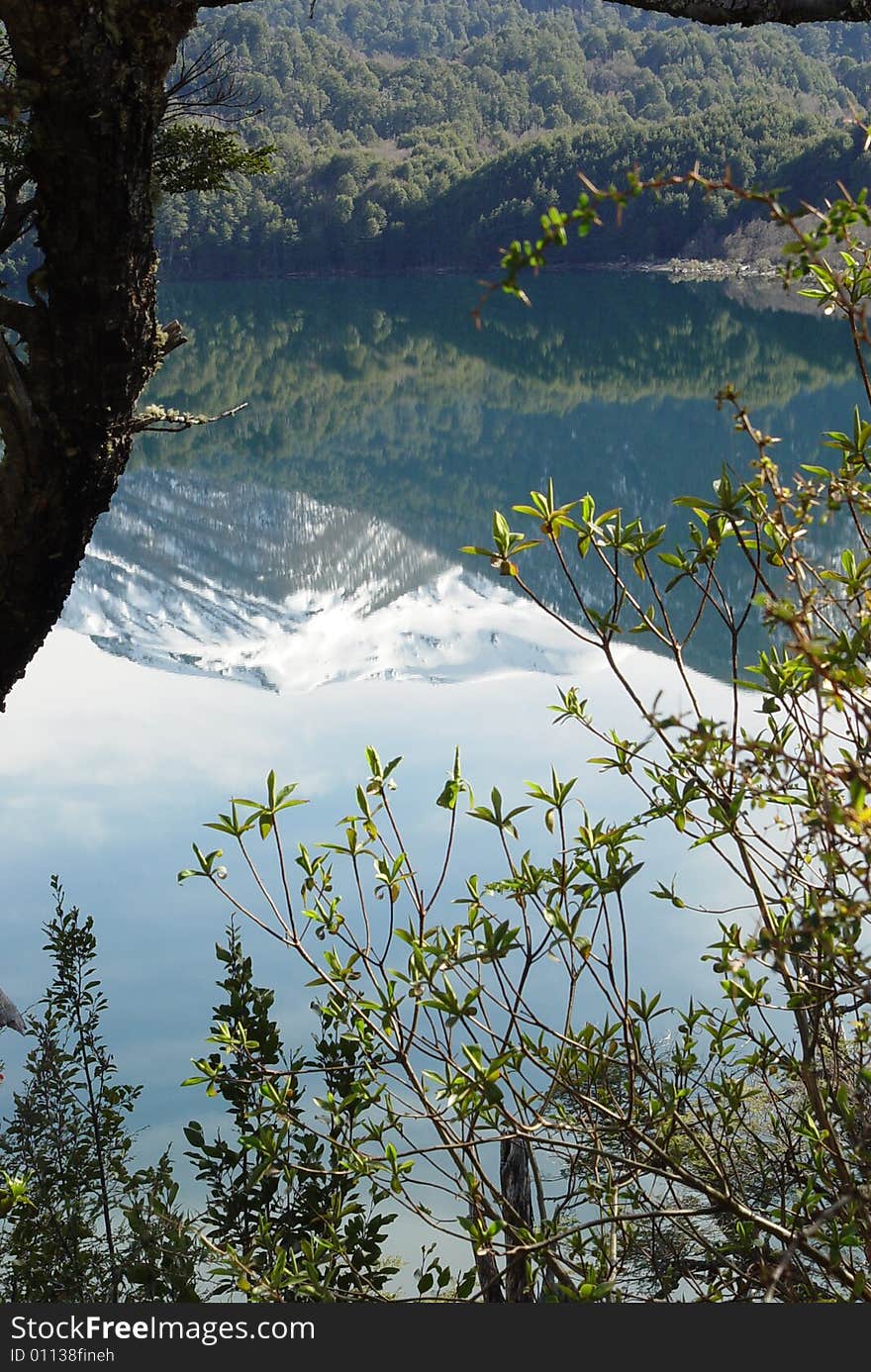 Snow-capped mountains are reflected on the lake. Snow-capped mountains are reflected on the lake