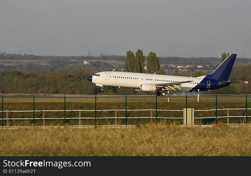 Plane touching ground on the runway. Plane touching ground on the runway