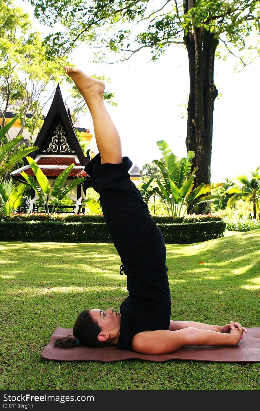 Young woman practicing yoga in the park.