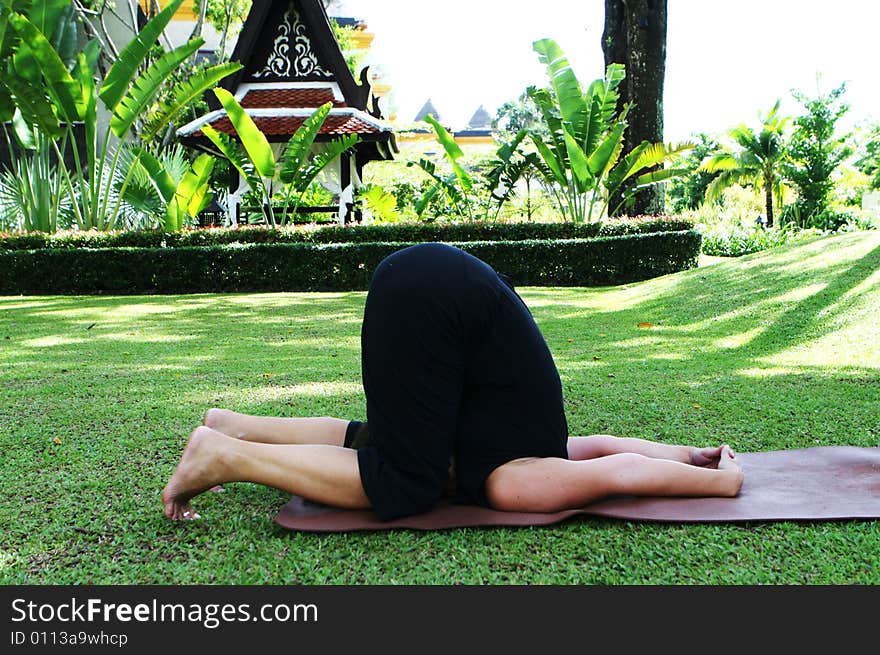 Young woman practicing yoga in the park.