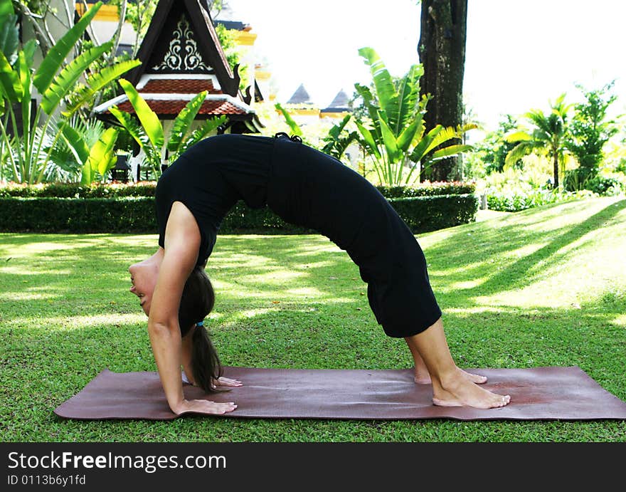 Young woman practicing yoga in the park.