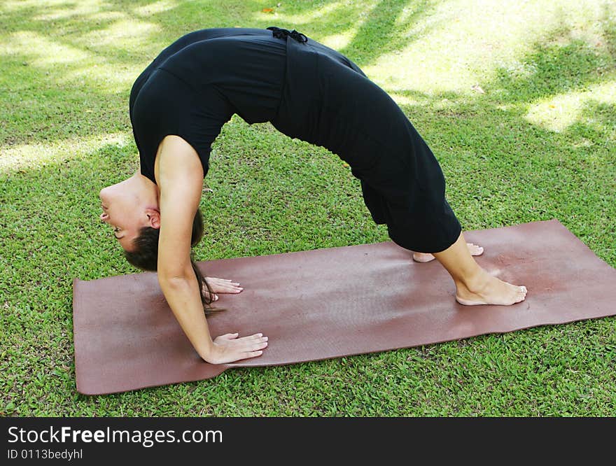 Young woman practicing yoga in the park.