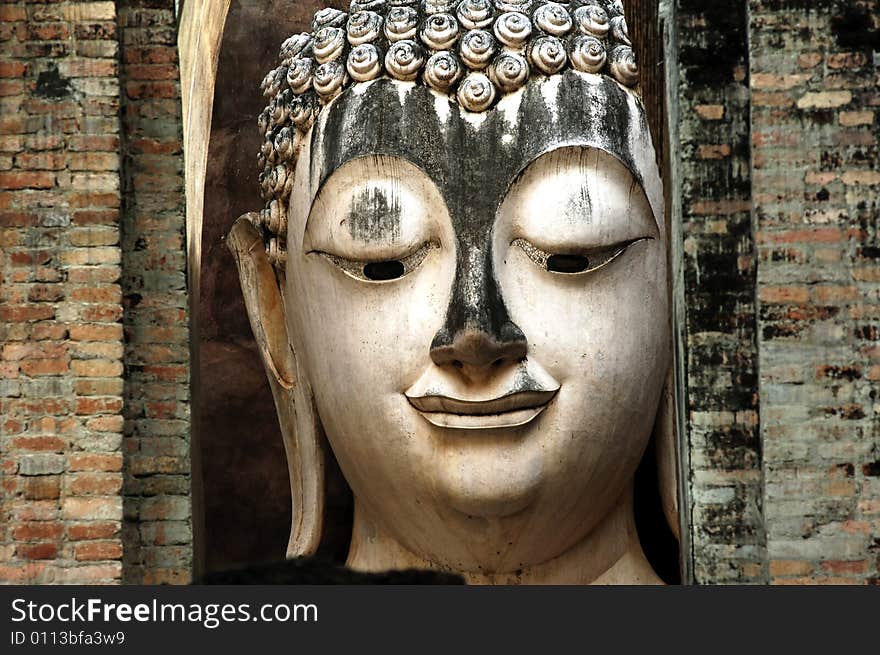 Thailand, Sukhothai or Sukothai was the capital of the Thai Empire founded in 1238. Detail of a seated Buddha at Wat Si Chum, Phra Atchana or Ajana. Thailand, Sukhothai or Sukothai was the capital of the Thai Empire founded in 1238. Detail of a seated Buddha at Wat Si Chum, Phra Atchana or Ajana.