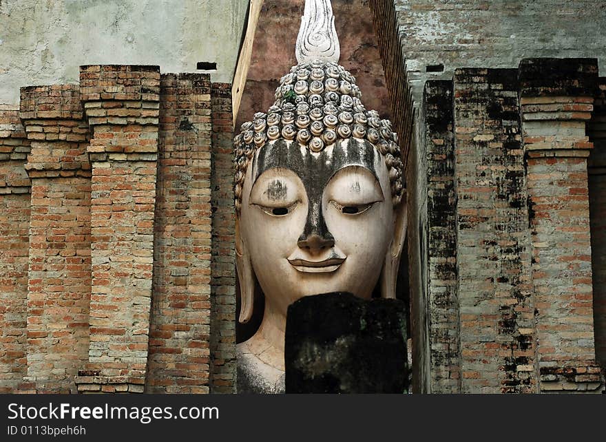 Thailand, Sukhothai or Sukothai was the capital of the Thai Empire founded in 1238. Detail of a seated Buddha at Wat Si Chum, Phra Atchana or Ajana. Thailand, Sukhothai or Sukothai was the capital of the Thai Empire founded in 1238. Detail of a seated Buddha at Wat Si Chum, Phra Atchana or Ajana.