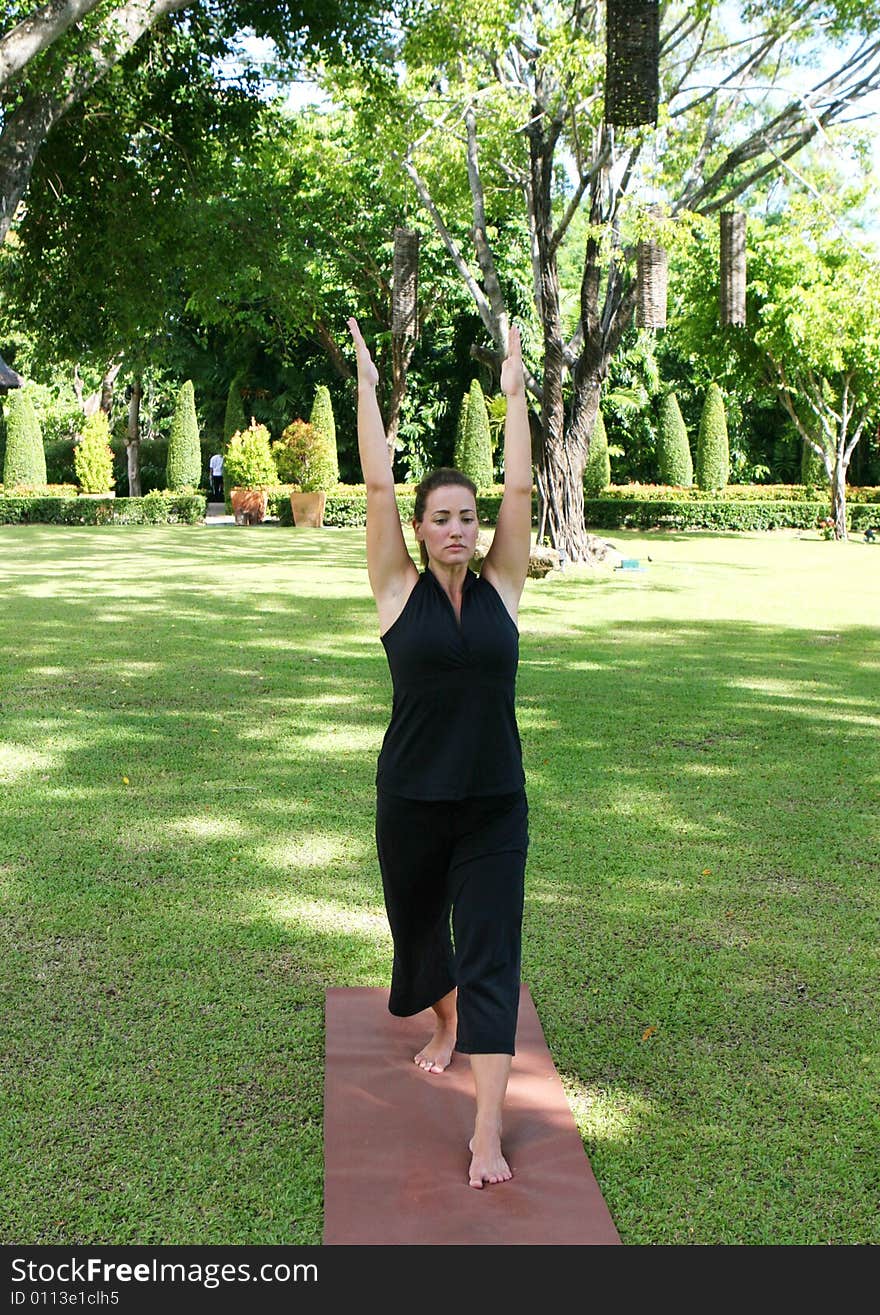 Young woman practicing yoga in the park.