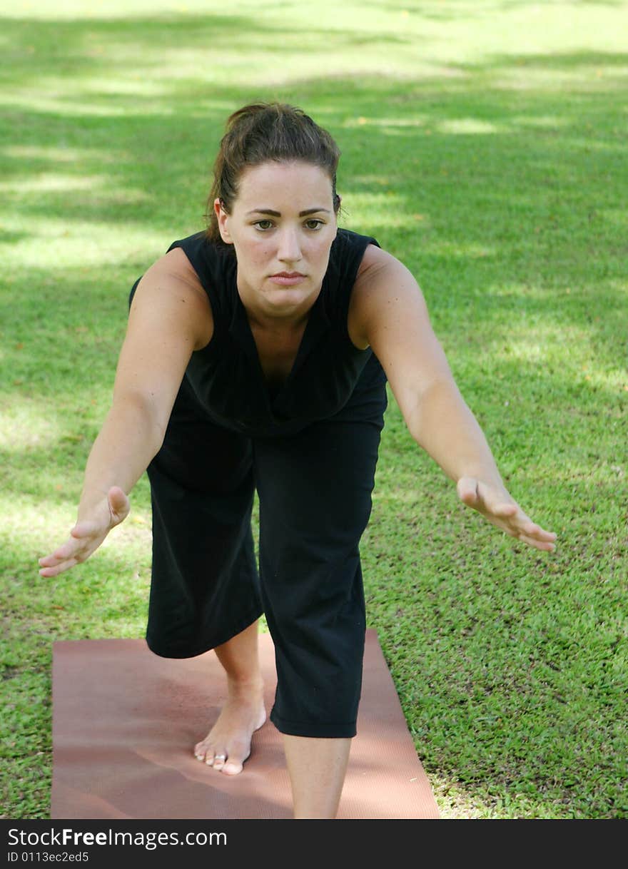 Young woman practicing yoga in the park.