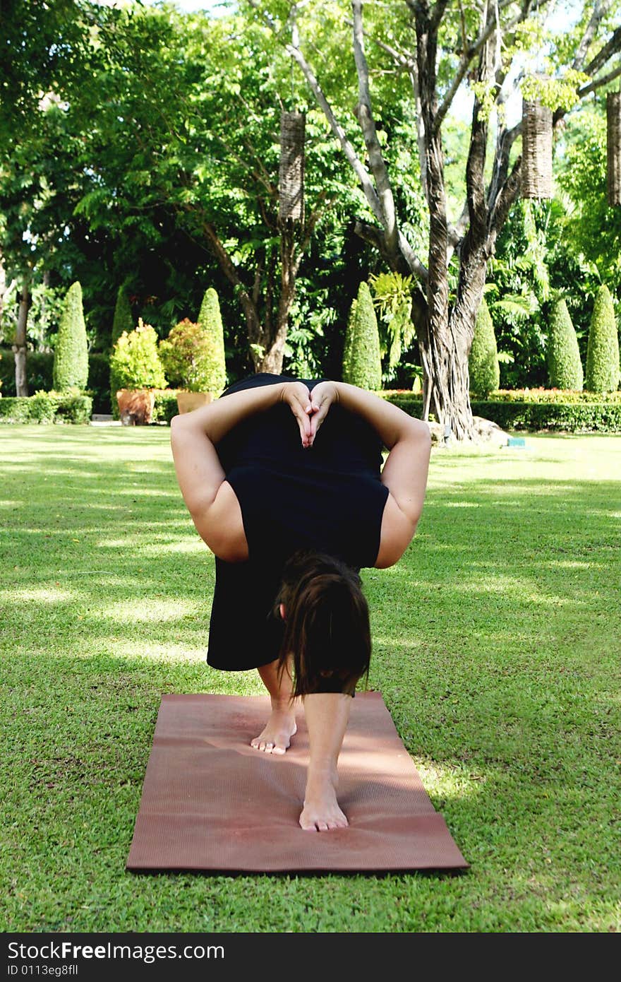 Young woman practicing yoga in the park.