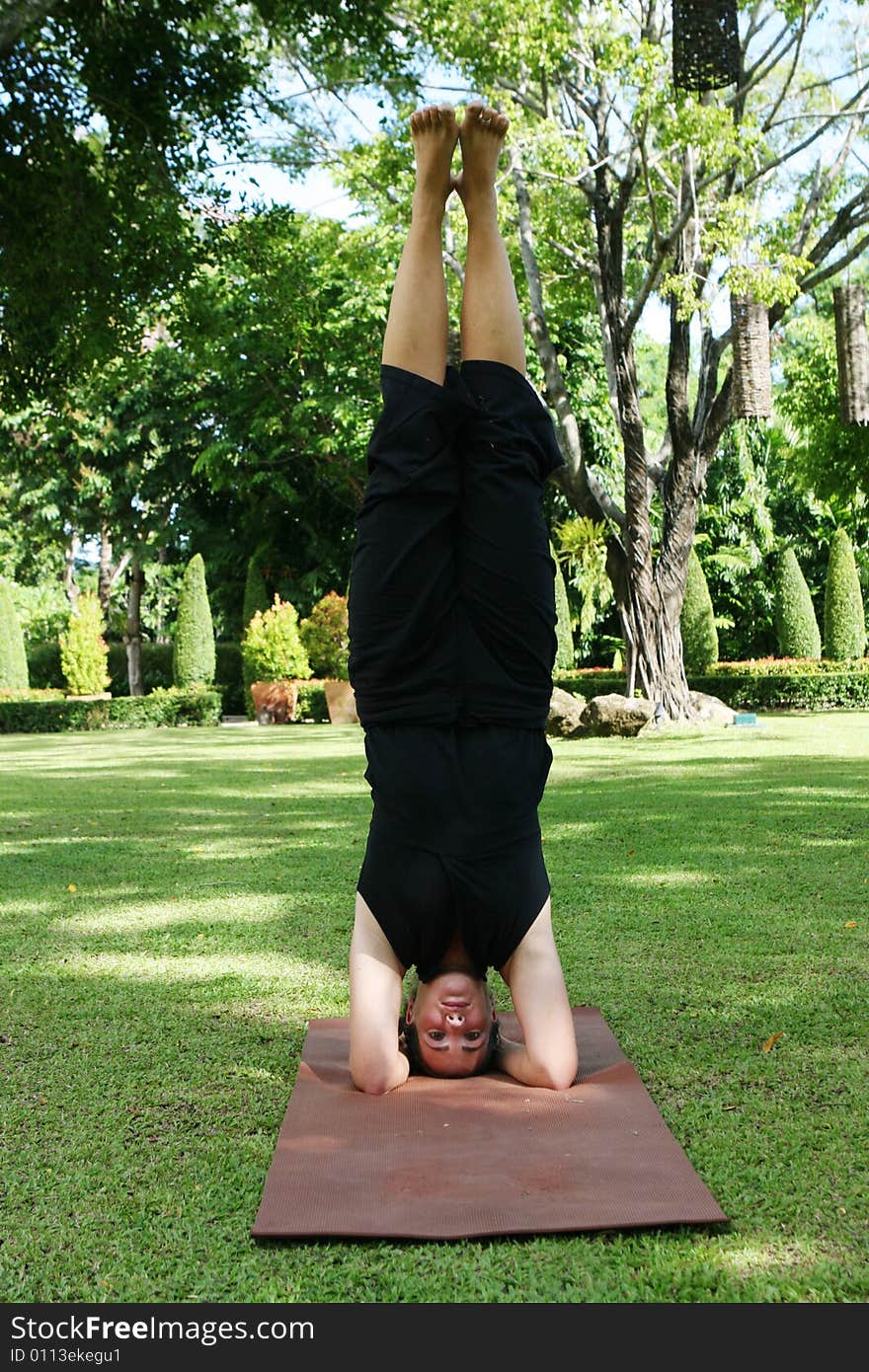 Young woman practicing yoga in the park.