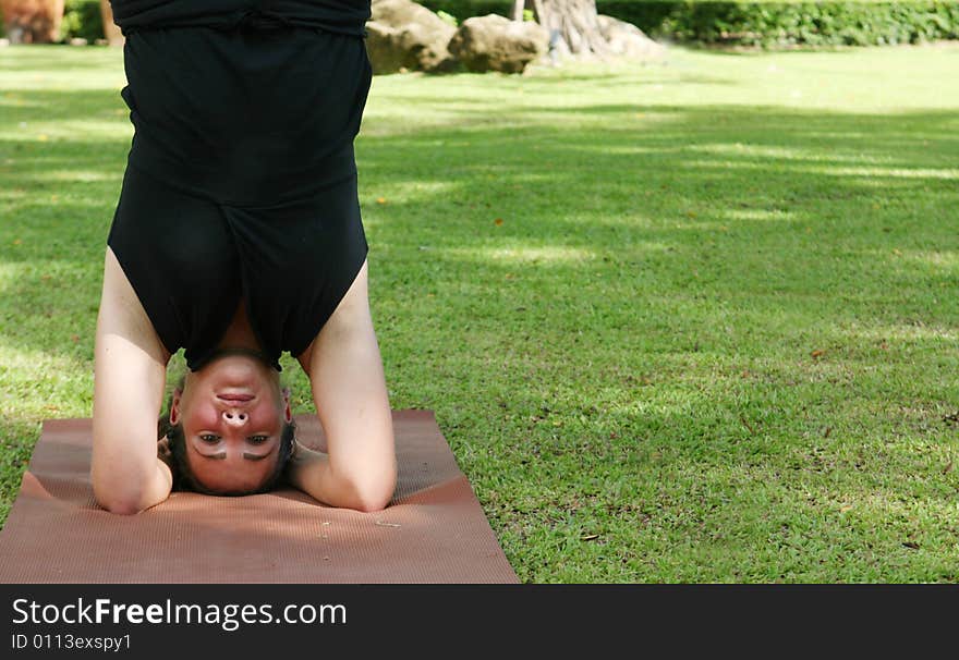 Young woman practicing yoga in the park.