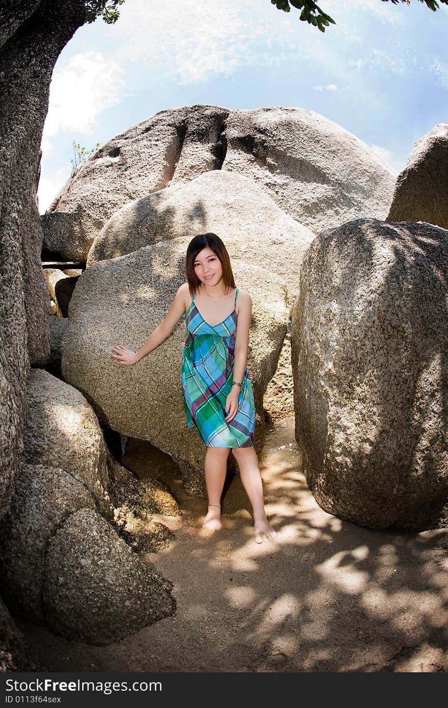 Young asian woman outdoor surrounded by big rocks. Young asian woman outdoor surrounded by big rocks