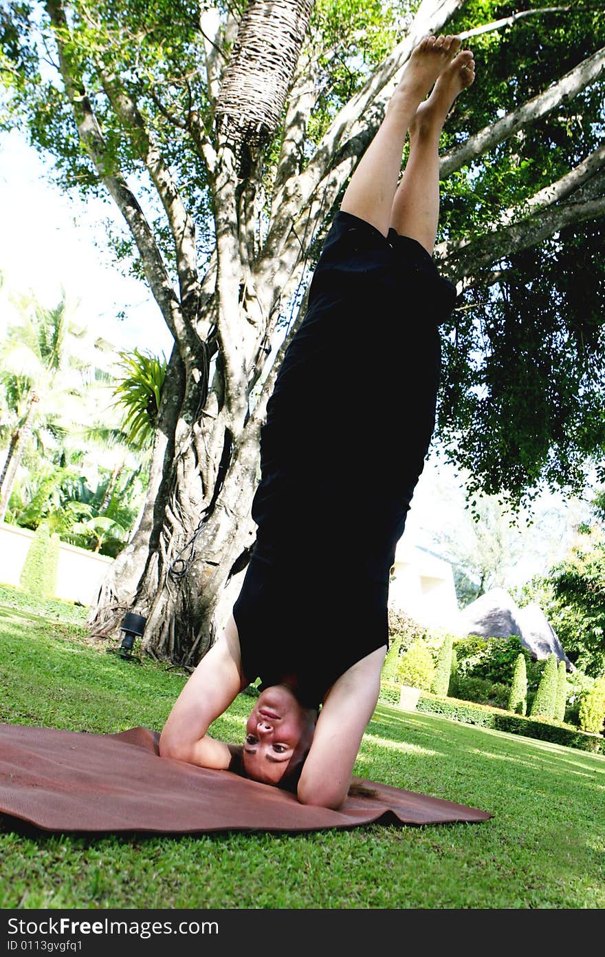 Young woman practicing yoga in the park.