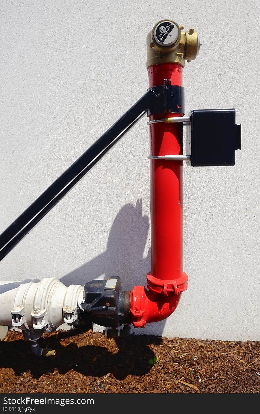 Red Fire Hydrant next to a wall