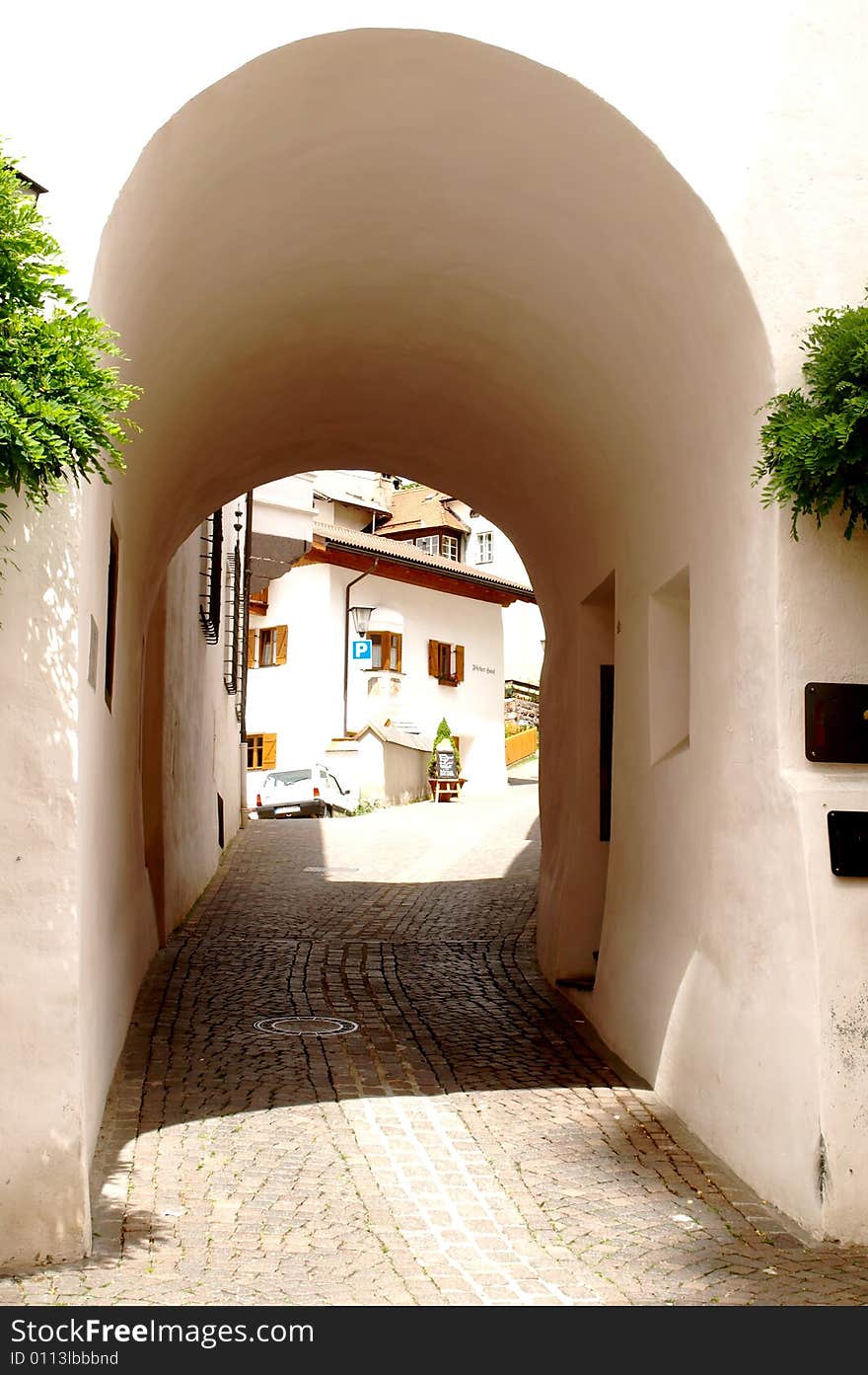 A glimpse of Castelrotto through an arc. A glimpse of Castelrotto through an arc