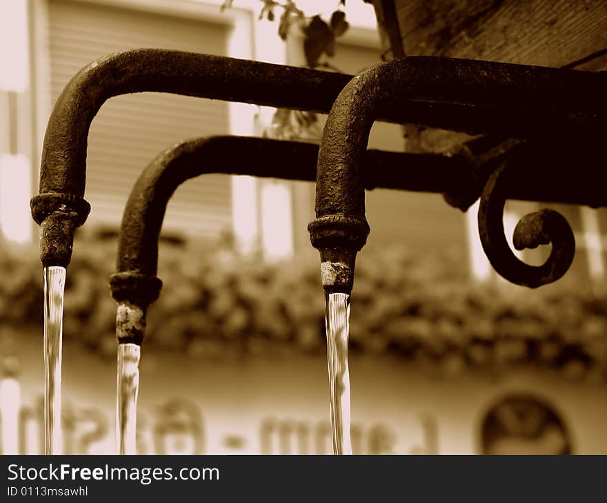 A suggestive shot of three pipes of an ancient fountain. A suggestive shot of three pipes of an ancient fountain