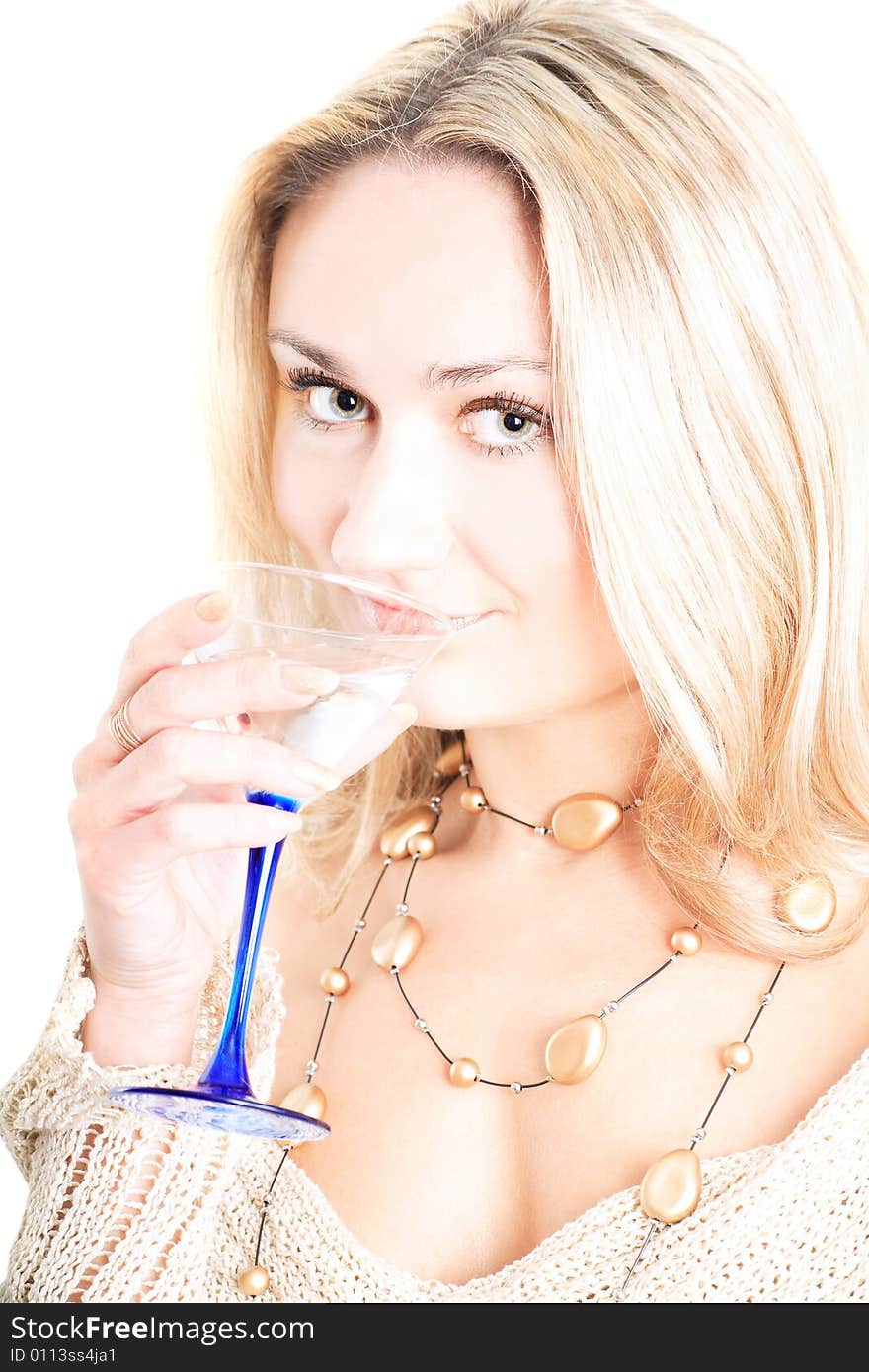 Portrait of a lovely blonde in pullover holding a glass on white background. Portrait of a lovely blonde in pullover holding a glass on white background