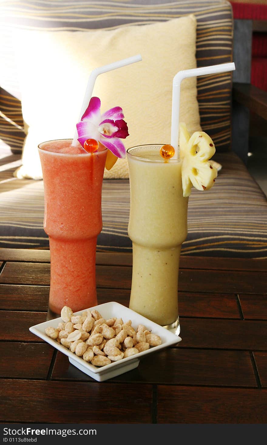 Tropical fruit shakes and a bowl of nuts. Tropical fruit shakes and a bowl of nuts.