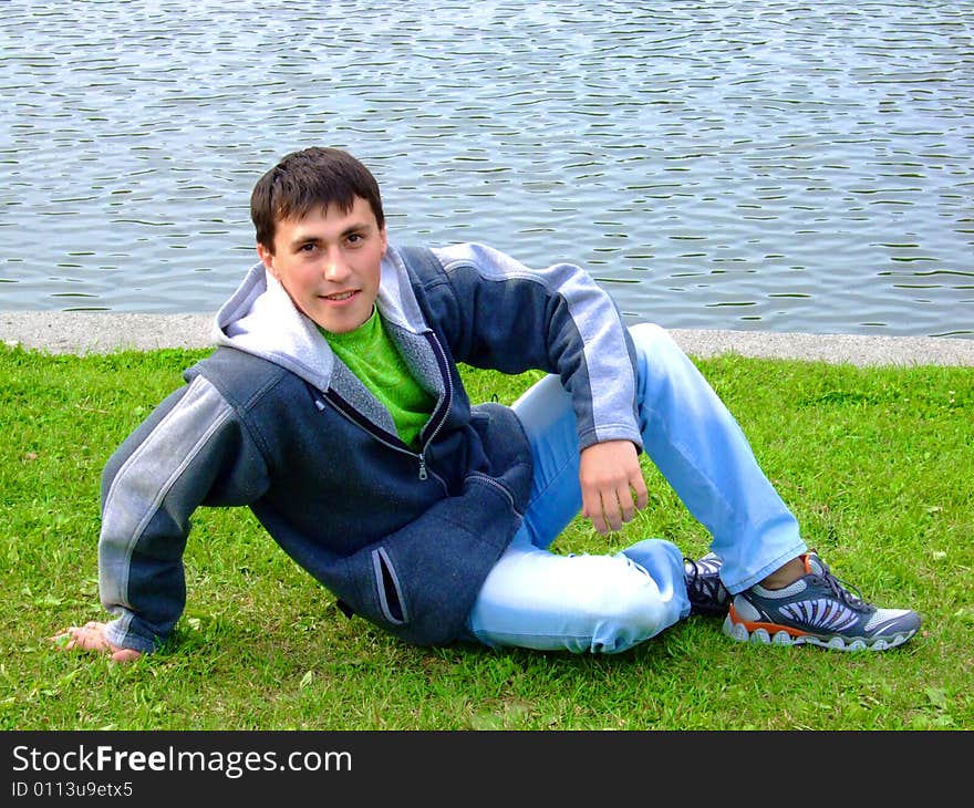 Photo of the young man on coast of the river.