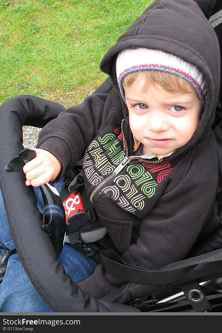 Blue eye boy in a stroller