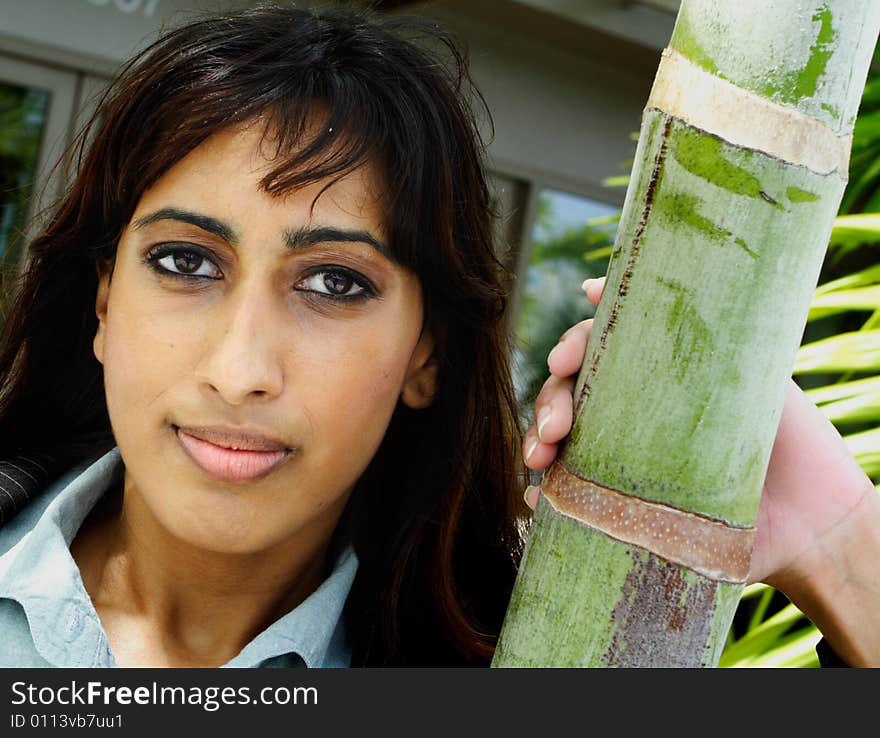 Young Islamic Female Posing For a Headshot next to a Palm Tree