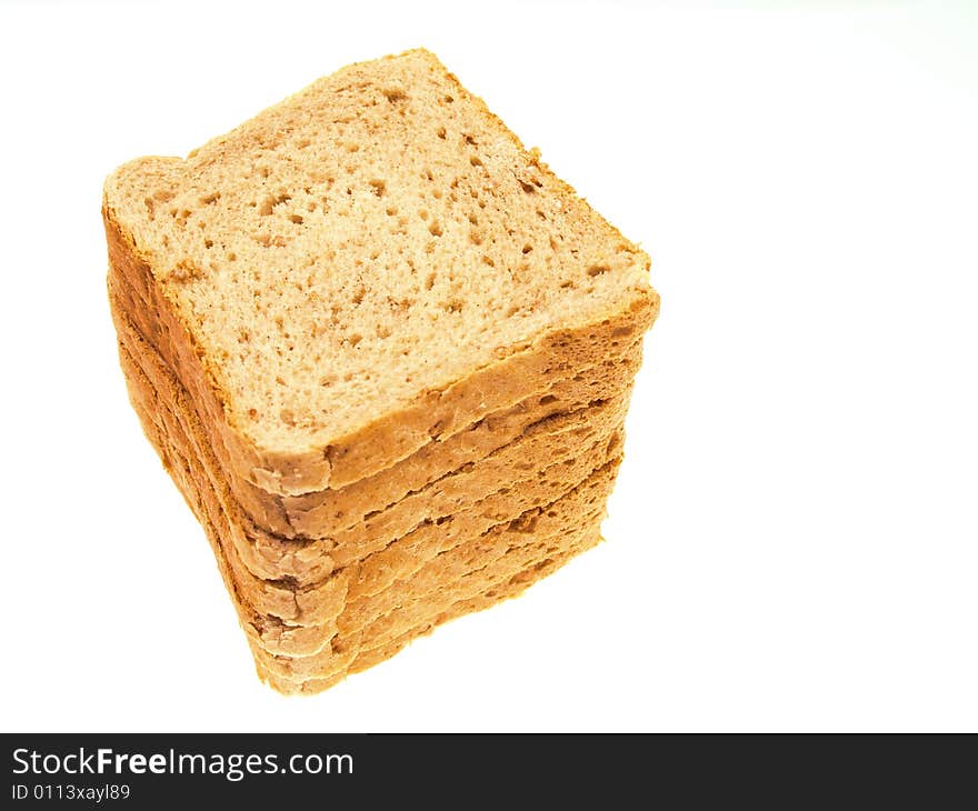 Slices of bread piled on top of each other isolated on white. Slices of bread piled on top of each other isolated on white