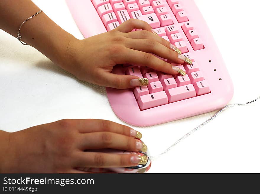 Hands of the girl on keyboard and mouse