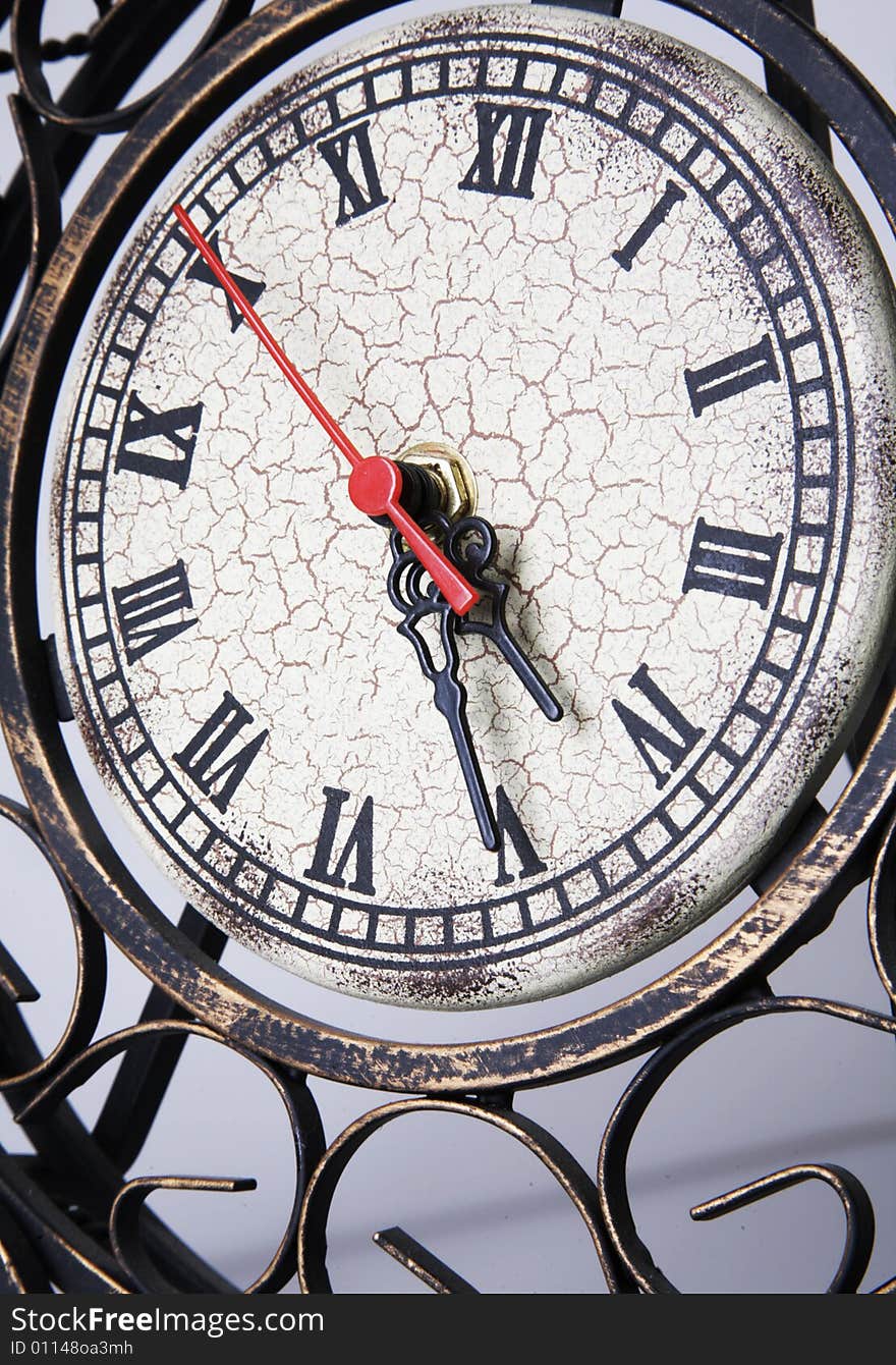 Old vintage metal clock with red arrow