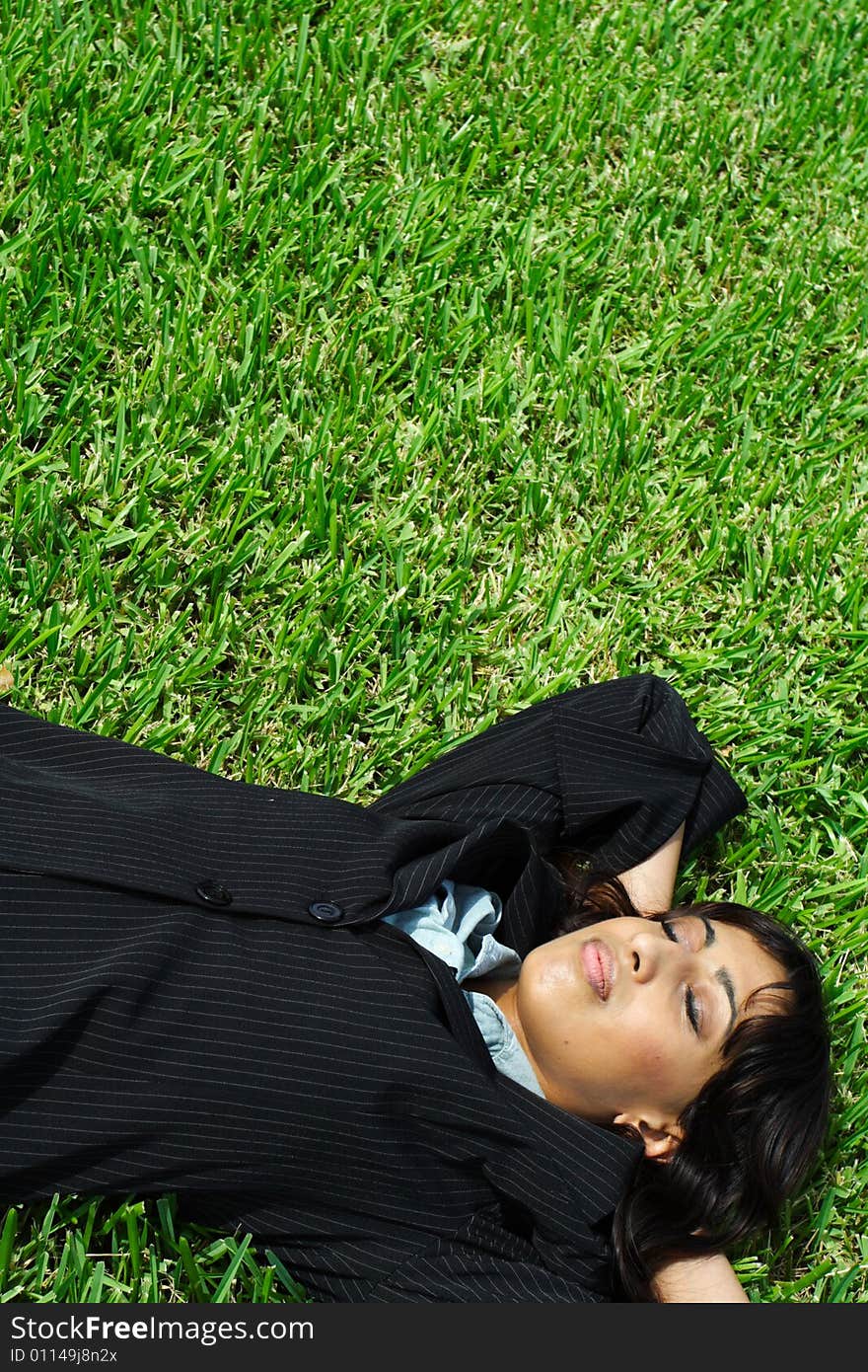 Businesswoman Napping On Grass