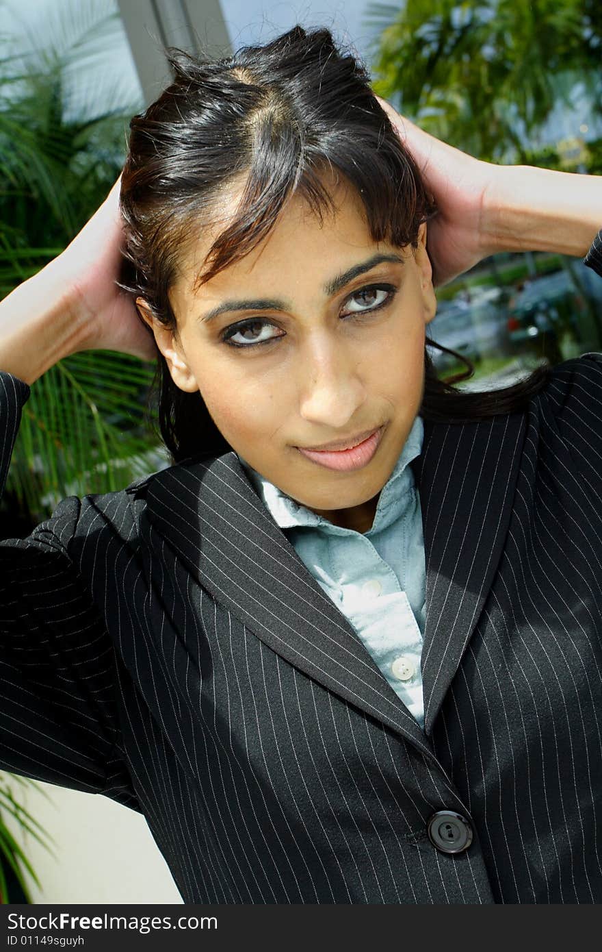 Young businesswoman pulling back her hair.