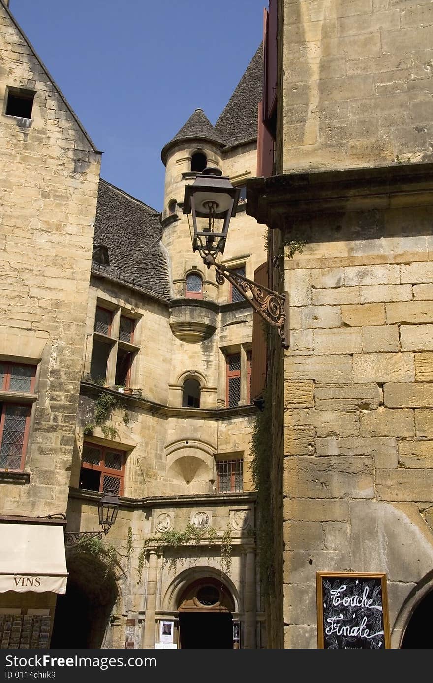 Old French street scene with tower and lamp