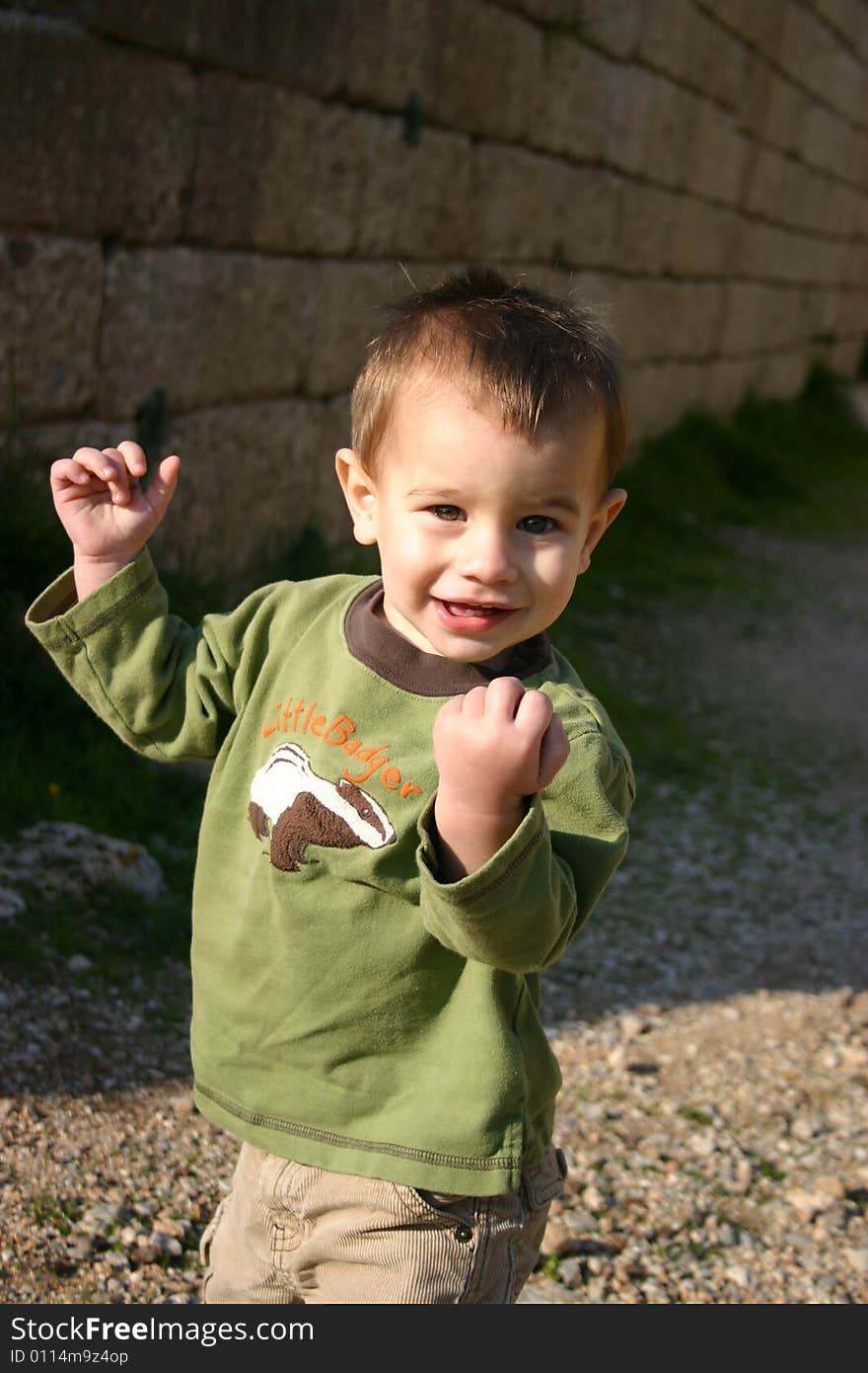 A boy playing and walking around a tour sight. A boy playing and walking around a tour sight.