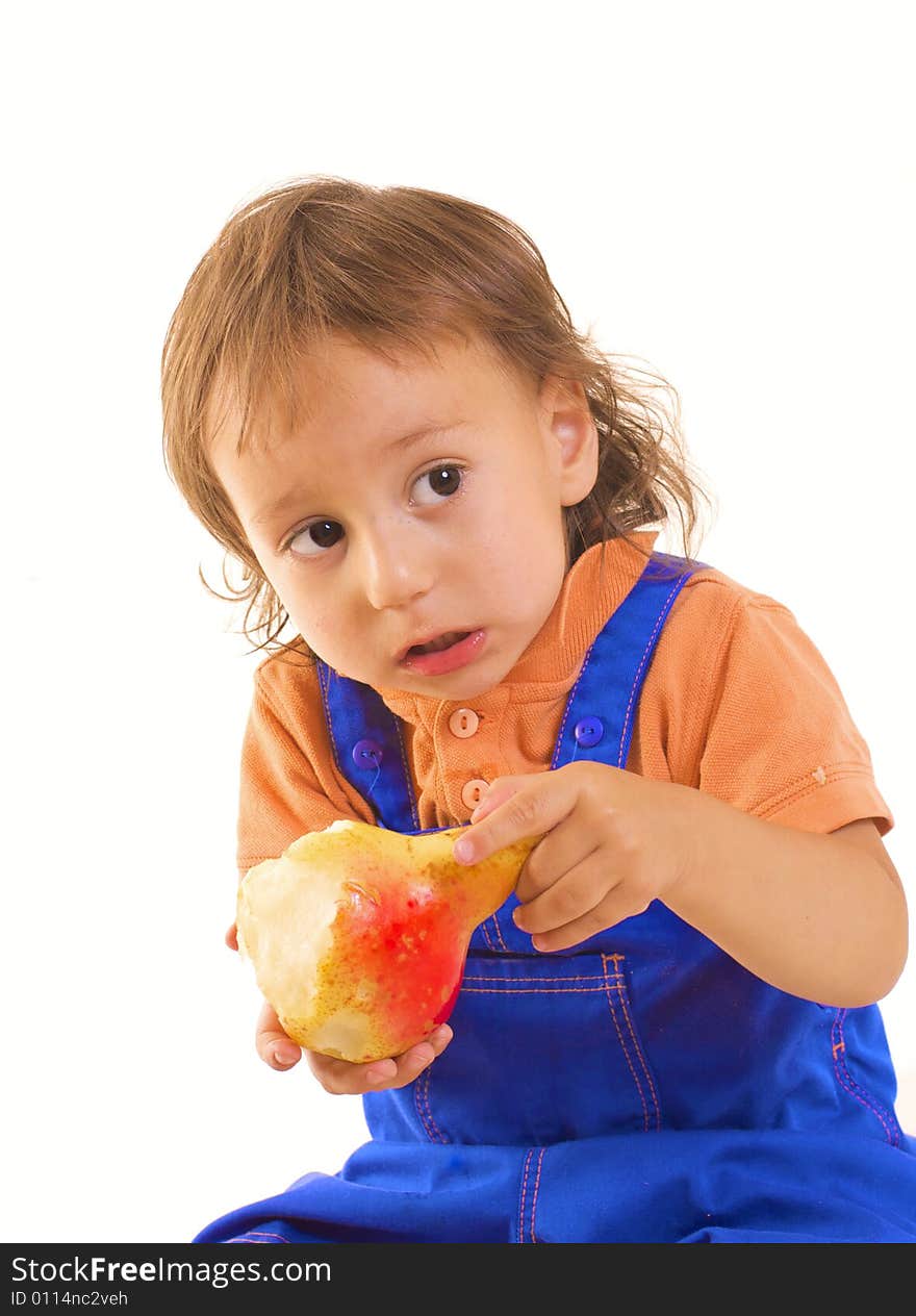 Little boy is eating pear on white background. Little boy is eating pear on white background