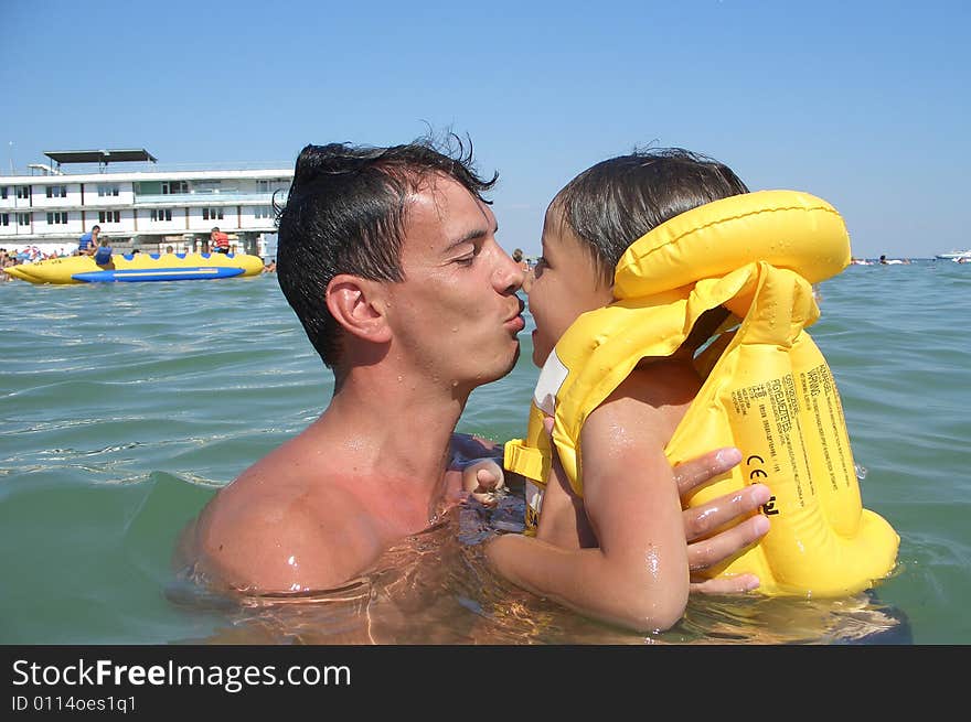 Happy father and son swimming