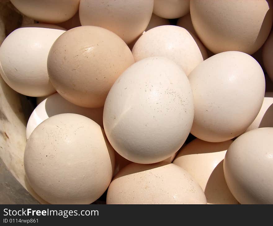 Several natural white hen eggs in a basket. Several natural white hen eggs in a basket