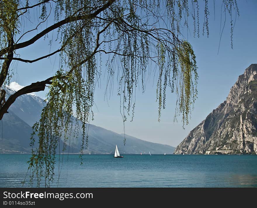 Lonely sailon a summer day - italy lake garda. Lonely sailon a summer day - italy lake garda