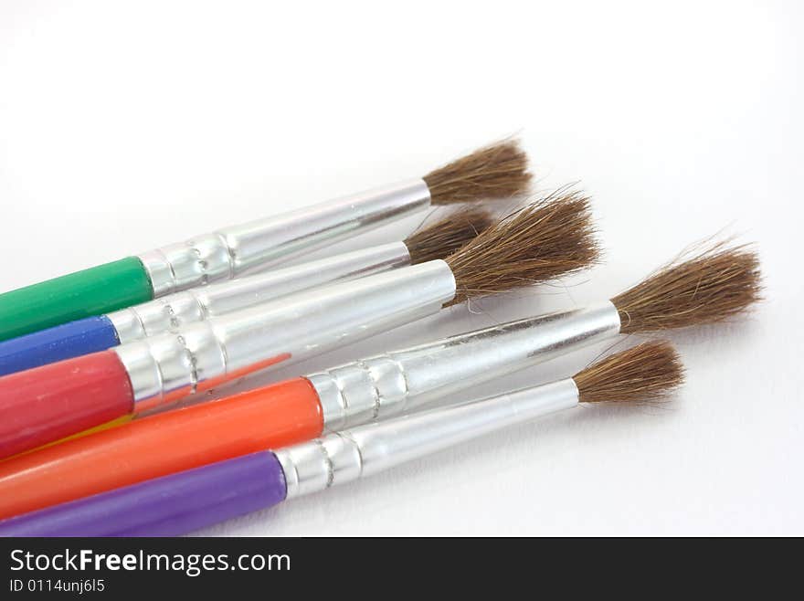 A set of children's paint brushes on a white background. A set of children's paint brushes on a white background.