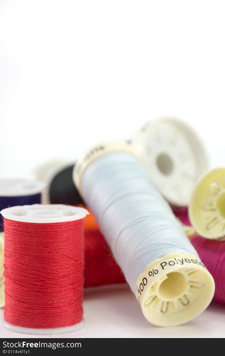 Colored cotton reels on a white background. Colored cotton reels on a white background.