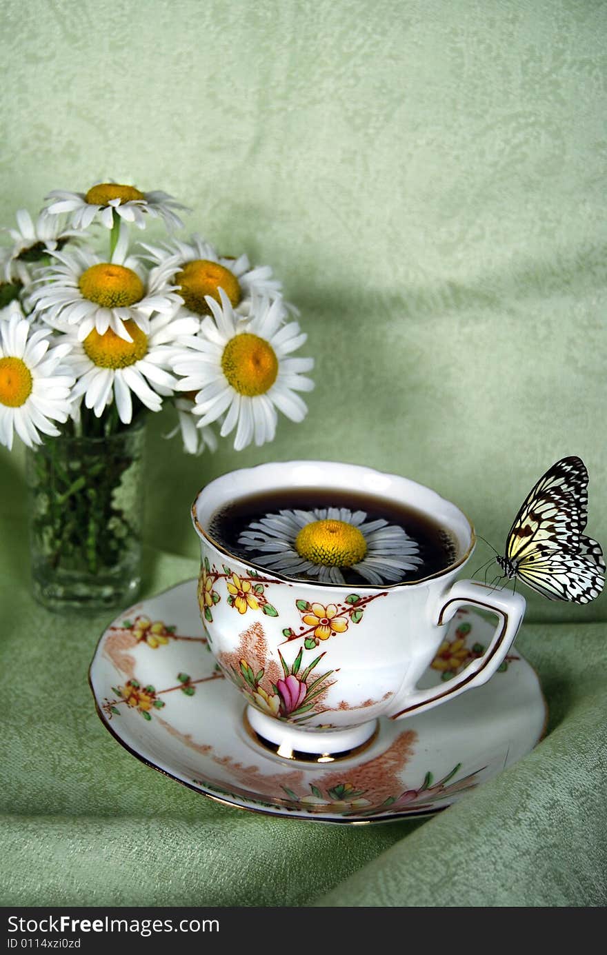 Butterfly on a vintage teacup. Butterfly on a vintage teacup.