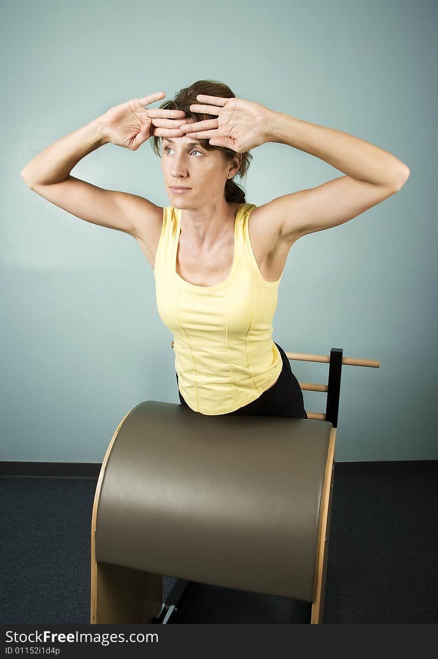 Athletic Woman Exercising and Stretching on Gym Equipment