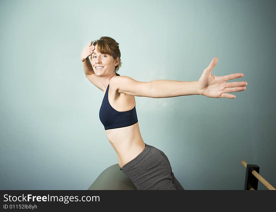 Athletic Woman Exercising and Stretching on Gym Equipment