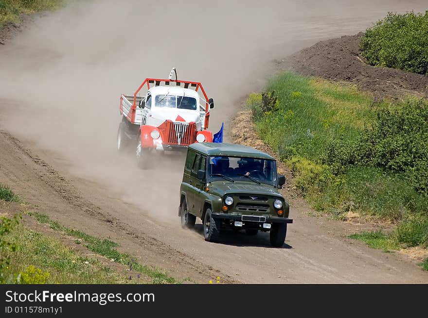 Lorry and car in competition of off-road rally. Lorry and car in competition of off-road rally