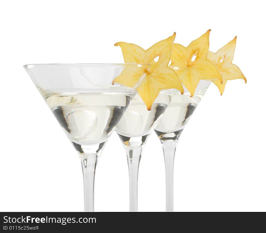 Glass of martini and slice of carambola on a white background. Glass of martini and slice of carambola on a white background