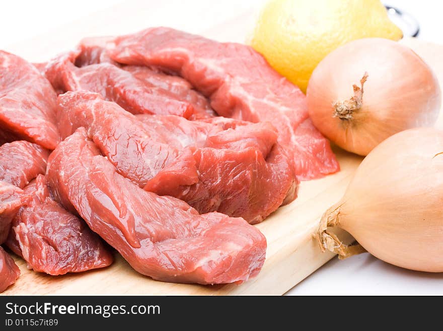 Fresh meat with vegetables on a white background. Close up.