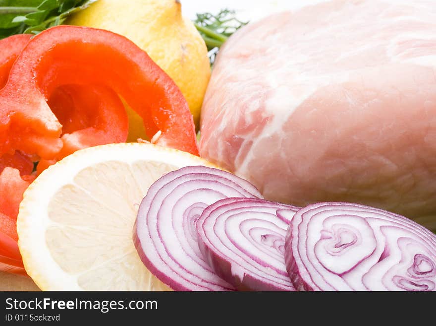 Fresh meat with vegetables on a white background. Close up.