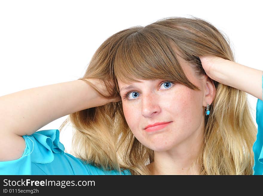 Nice blue-eyed girl adjust her hair on white background