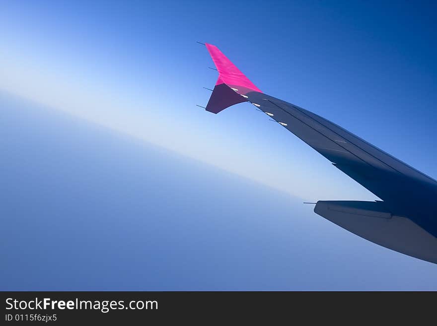 Aircraft wing flying high above the clouds. Aircraft wing flying high above the clouds